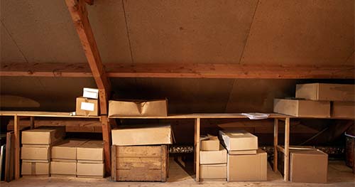 Image: storage shelves in an attic.